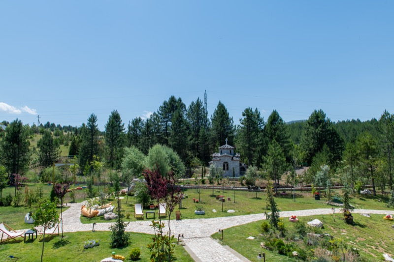 Lush organic farm and surrounding green grounds of the Ura e Kovaçit estate