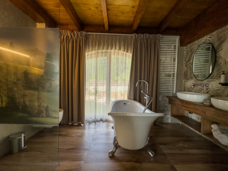 Superior Double Room featuring elevated luxury, a plush double bed, and large windows with scenic mountain views
