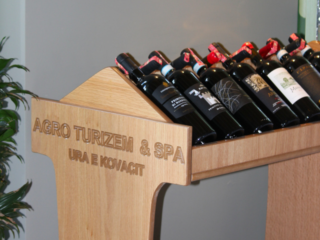 Exquisite wine tasting table with red wine glasses and locally sourced organic cheeses at Ura e Kovaçit
